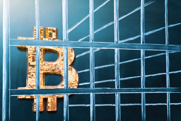 Bitcoin in prison. Concept of arrest, fraud and deception with cryptocurrency and mining. Bitcoin ban, imprison or illegal. Big troubles for bitcoin stock photo