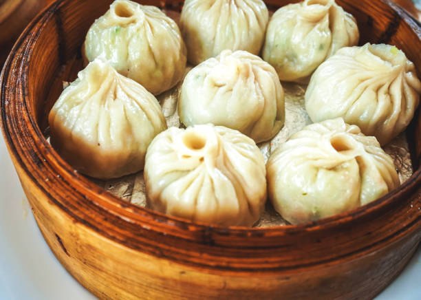 istock steamed dumplings in wooden basket 1304532227