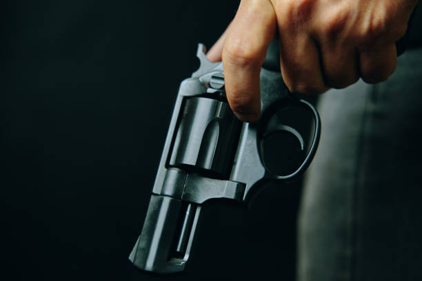 istock Black revolver with drum in man's hand. 1304532292