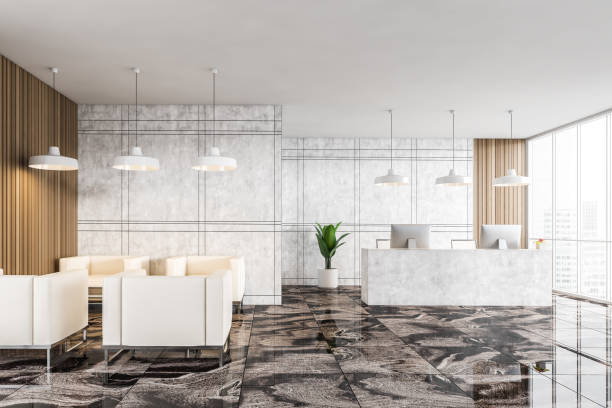 istock Reception hall with armchairs and desk with computers, marble and tiled design 1304532299