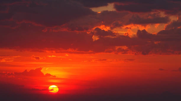 istock Orange sunset with moody blue clouds in the sky 1304533143