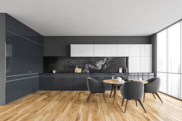istock Black and white kitchen with table and four chairs near window 1304533258