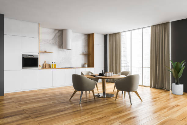 istock Wooden and beige kitchen set with dining table near window with curtains 1304534192
