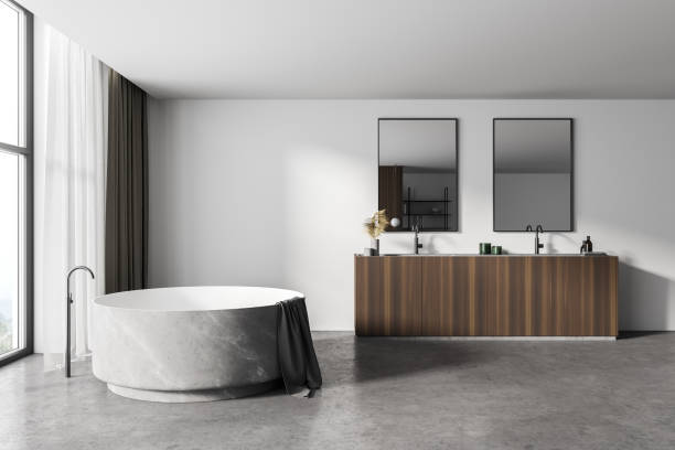 istock White bathroom interior with round tub and sink 1304534385