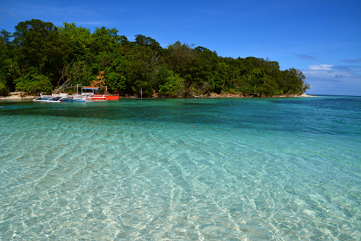 Idyllic Mantigue island crystal clear water, Camiguin, Mindanao, Philippines.