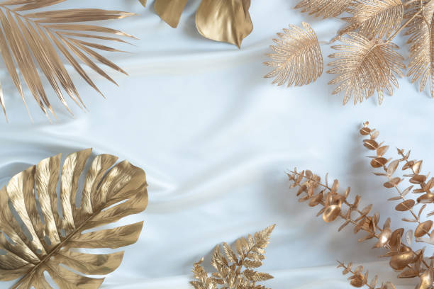 istock Gold tropical palm leaves Monstera on white background. 1304535494