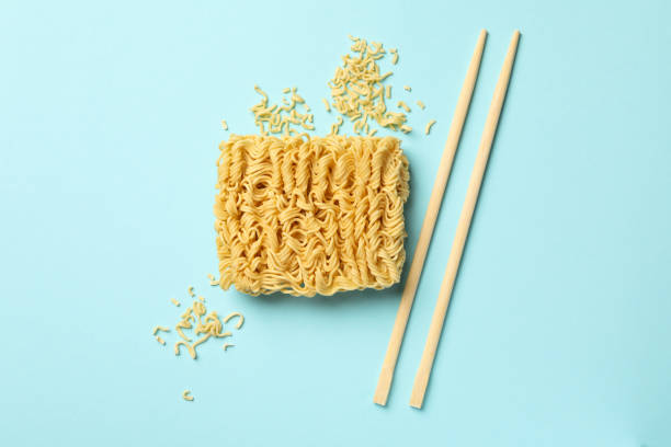 istock Instant noodles and chopsticks on blue background 1304536821