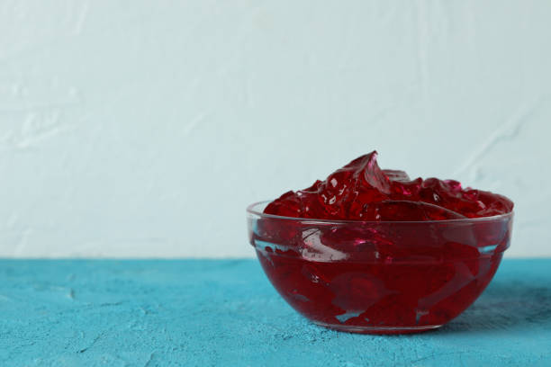 istock Bowl of strawberry jelly on blue table 1304538241