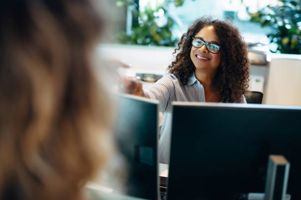 istock Receptionist assisting female visitor in office 1304538266