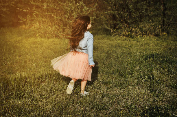 istock Little girl posing in the dark meadow. 1304538531