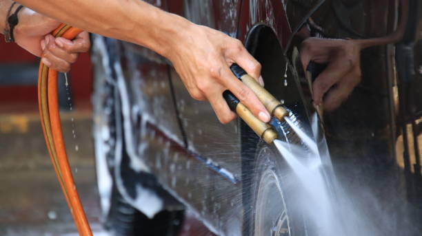 istock worker car cleaning, spraying and wiping, at his workplace 1304539031