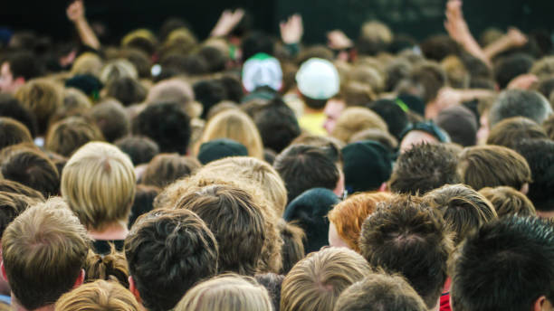 istock Crowd of people standing seen from behind 1304539672