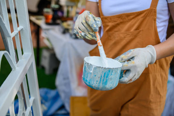 istock Painter woman painting for house improvement when lock down during Covid-19. 1304539942