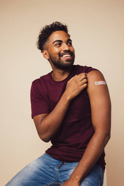istock Man showing his shoulder after receiving a vaccine 1304540020