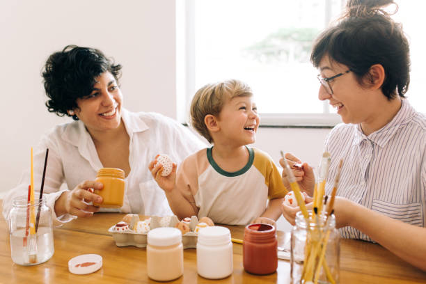 istock Family having fun painting eggs for Easter 1304540188