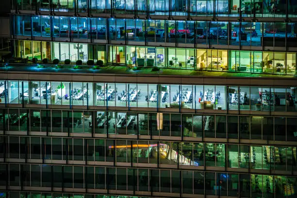 Close up of highly detailed and illuminated modern offices during night hours in London City, UK, photographed on Canon EOS R full frame system.