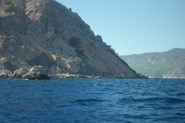 istock Summer seascape with mountains and blue sea water. 1304540396