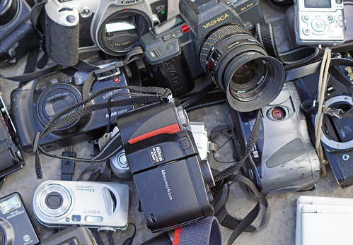 Belgrade, Serbia - November 6, 2016: Big bunch of old digital and analog film cameras at flea market in Zemun.