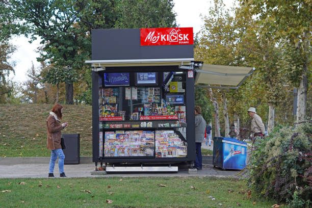 Belgrade, Serbia - October 5, 2016: People shopping at news agent kiosk in Belgrade park.