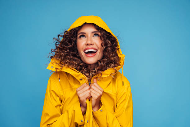 istock Smiling beautiful woman in raincoat 1304541735