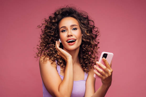 istock Woman in wireless earbuds with smart phone 1304542437