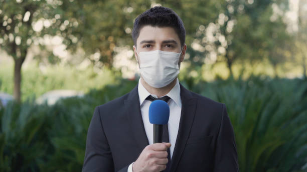istock TV reporter wearing a face mask 1304543498