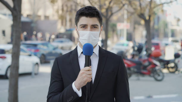 istock TV reporter wearing a face mask 1304543638