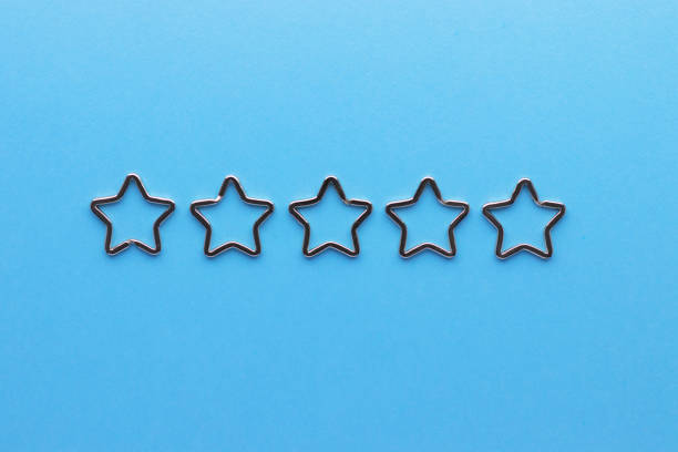 istock Five shiny metal split key rings in shape of star for keychains. Chromium plated keychain clasp on blue background. Feedback concept. Flat lay, top view with copy space. 1304546196