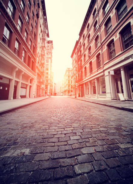 Soho, New York Cobbled Soho street in New York with added sun effect and filter soho new york stock pictures, royalty-free photos & images