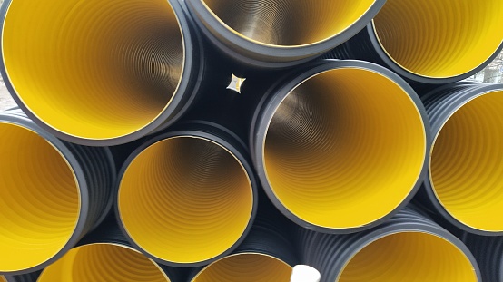 black construction pipes. corrugated pipes coated inside yellow
