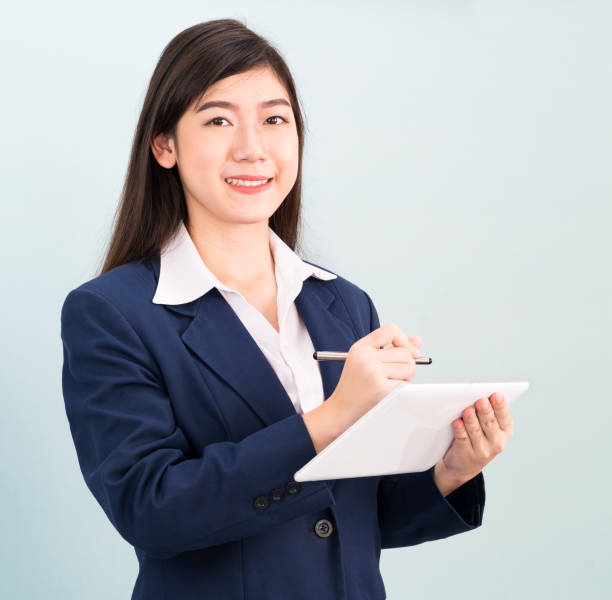 istock Teenage girl in suit using computer digital tablet 1304549506