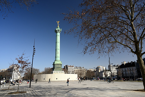 Paris, France - February 25, 2021: Colonne de Juillet with a statue on the top called le Génie de la Bastille. This place is where the french revolution started in 1789