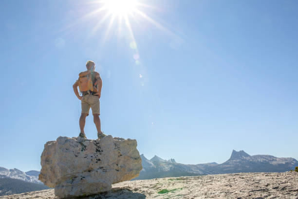 istock Hiker balances on a rock boulder above mountains 1304553414