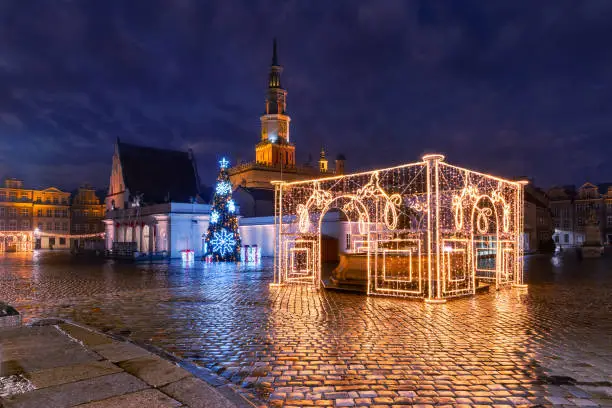 Poznan Town Hall and decorated fountain on Old Market Square in Old Town in the Christmas night, Poznan, Poland