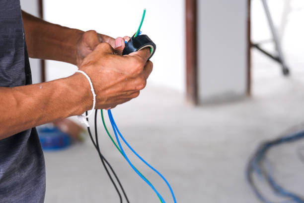 istock Electrician male working install wire power cable . professional technician worker use black electric tape connect electric cable in house site. 1304556488