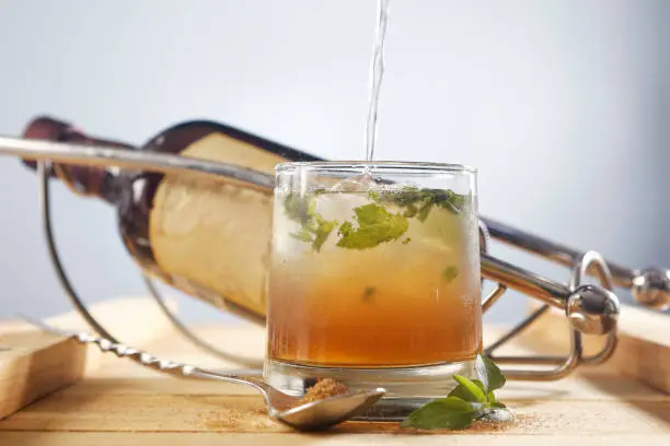 Photo of Mojito cocktail, served with rum, lemon, mint, eucalyptus and mineral water and sugar.