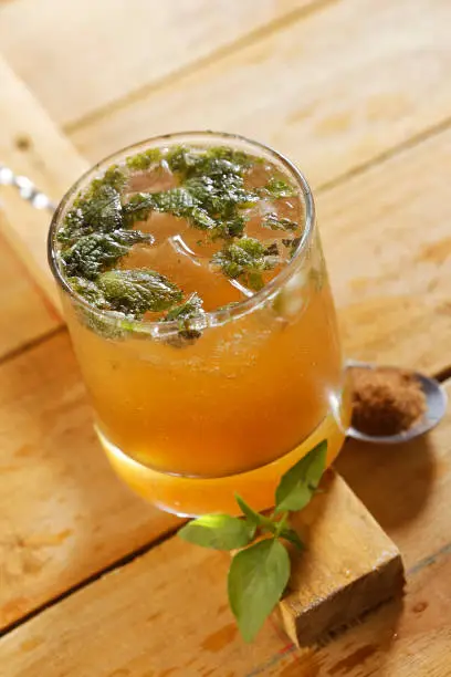 Photo of Mojito cocktail, served with rum, lemon, mint, eucalyptus and mineral water and sugar.