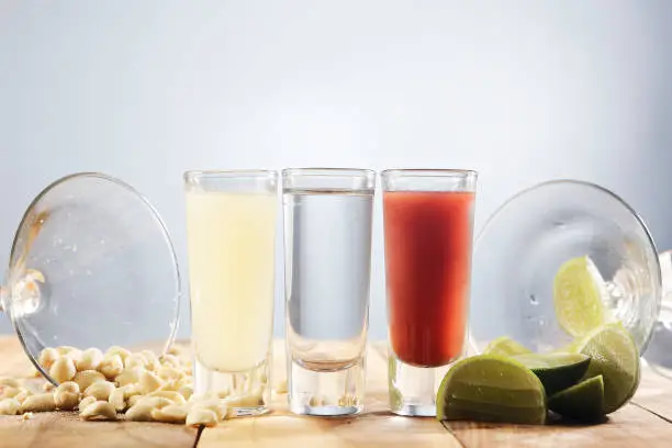 Photo of Set of three shot glasses known in Mexico as Bandera and served with lemon juice, tequila, and sangria.