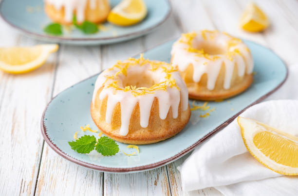 Mini lemon bundt cakes topped with lemon glaze stock photo