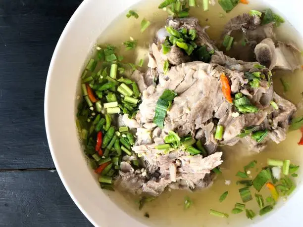 Photo of Giant dish of Thai style food. Hot and Spicy Soup with Pork Ribs. Spicy Pork with Pork bone Soup (Lang Zaap). Is a spicy and popular food in Thailand Tourists like it very much.