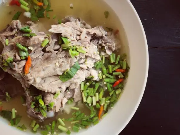 Photo of Giant dish of Thai style food. Hot and Spicy Soup with Pork Ribs. Spicy Pork with Pork bone Soup (Lang Zaap). Is a spicy and popular food in Thailand Tourists like it very much.