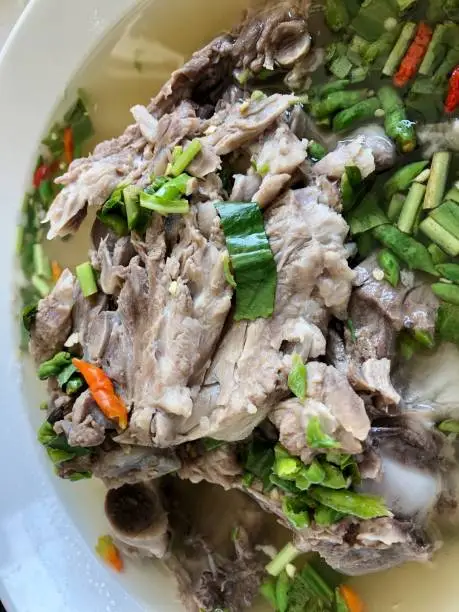 Photo of Giant dish of Thai style food. Hot and Spicy Soup with Pork Ribs. Spicy Pork with Pork bone Soup (Lang Zaap). Is a spicy and popular food in Thailand Tourists like it very much.