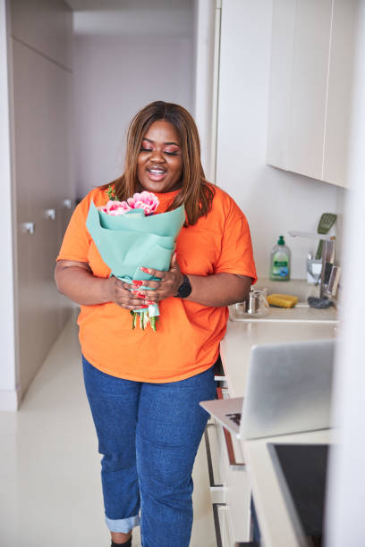 istock Smiley woman feeling thankful about her fresh flowers 1304560943