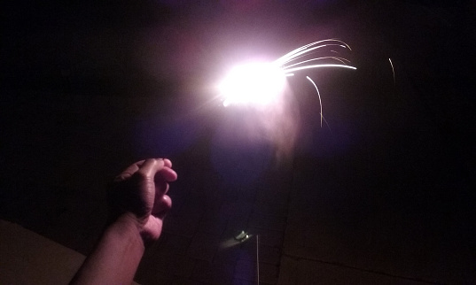 A snapshot of a lit sparkler that is held in my hand...as I celebrate the Fourth of July.