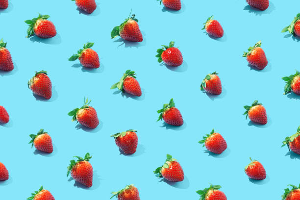 istock Seamless pattern of fresh strawberries on blue background. Top view. 1304561541