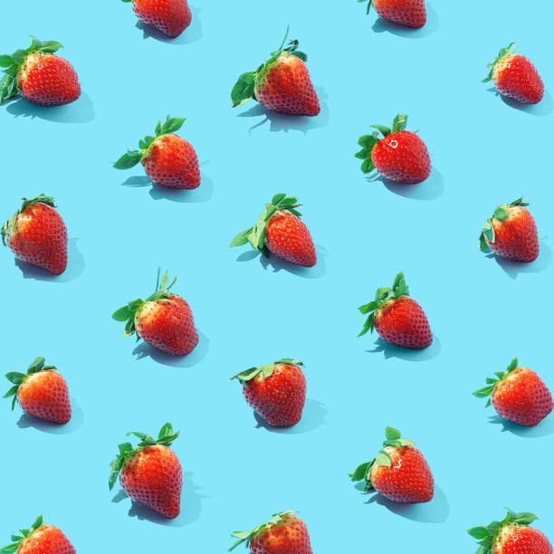 istock Seamless pattern of fresh strawberries on blue background. Top view. 1304561556
