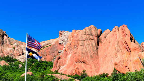 istock US & Colorado Flags in Front of Red Rock Formations 1304562537