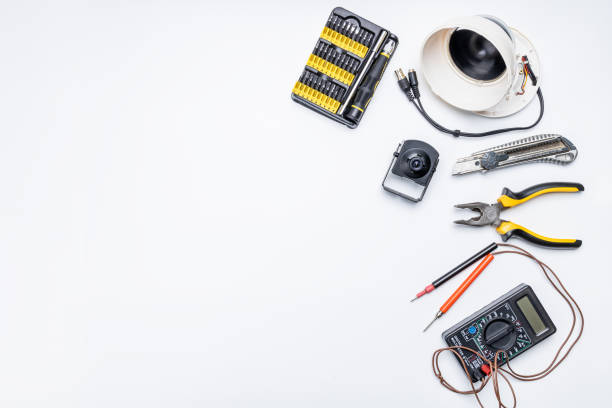istock cctv camera service repair concept. above view. adjusting surveillance camera using tools on white desk 1304563737