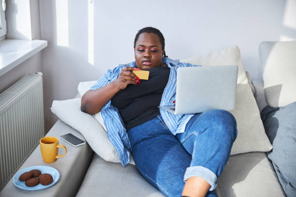 istock Pretty tranquil lady doing online shopping from her home 1304566805