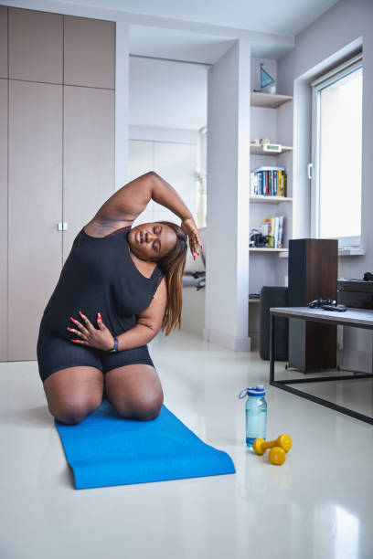 istock Mindful lady doing her morning exercises on a mat 1304566876